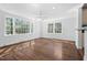 Bright living area with large windows, a ceiling fan, and wood floors, perfect for gatherings and relaxation at 55 Lindsey St, Pittsboro, NC 27312