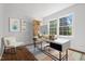 Bright home office featuring a modern desk, natural wood shelving, and large windows for natural light at 55 Lindsey St, Pittsboro, NC 27312