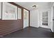 Cozy porch featuring rustic wood siding and contrasting trim and windows creates a welcoming entry at 55 Lindsey St, Pittsboro, NC 27312