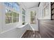 Bright sunroom featuring large windows, wood-look floors, and white trim throughout at 55 Lindsey St, Pittsboro, NC 27312