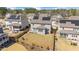 Aerial view of a fenced-in backyard with lawn, patio, and house with solar panels at 715 White Oak Pond Rd, Apex, NC 27523