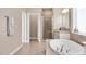 Elegant bathroom with granite countertops, double sinks, a large tub, and a glass shower at 715 White Oak Pond Rd, Apex, NC 27523