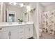 Bathroom featuring a double vanity with framed mirrors and a separate shower area at 715 White Oak Pond Rd, Apex, NC 27523