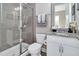 Bathroom featuring granite countertop vanity, framed mirror, and glass-enclosed shower at 715 White Oak Pond Rd, Apex, NC 27523