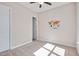Neutral bedroom with carpeted floors, ceiling fan, and ample natural light from the window at 715 White Oak Pond Rd, Apex, NC 27523