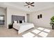 Bedroom with a large upholstered headboard, neutral carpet, and a view into the hallway at 715 White Oak Pond Rd, Apex, NC 27523