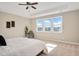 Bright bedroom featuring a ceiling fan, a large window with a view, and neutral tones at 715 White Oak Pond Rd, Apex, NC 27523