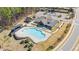 Stunning aerial view of a large community pool, clubhouse, and recreational area at 715 White Oak Pond Rd, Apex, NC 27523