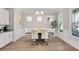 Elegant dining room showcasing modern chairs, a sleek table, crown molding, and a view of the backyard at 715 White Oak Pond Rd, Apex, NC 27523