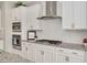 Modern kitchen featuring white cabinets, stainless steel appliances, granite countertops, and stylish backsplash at 715 White Oak Pond Rd, Apex, NC 27523