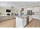 Open concept kitchen with large island, granite countertops, stainless steel appliances, and adjacent living area at 715 White Oak Pond Rd, Apex, NC 27523