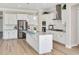 Modern kitchen featuring white cabinets, stainless steel appliances, and an island with granite countertops at 715 White Oak Pond Rd, Apex, NC 27523