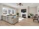 Bright living room with a large window, fireplace, ceiling fan, and comfortable seating at 715 White Oak Pond Rd, Apex, NC 27523