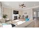 Bright living room with a fireplace, ceiling fan, large window, and comfortable sofa at 715 White Oak Pond Rd, Apex, NC 27523