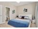 Bright main bedroom with a white bed frame and blue bedding, next to a full bathroom at 715 White Oak Pond Rd, Apex, NC 27523