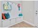 Functional mudroom with built-in storage bench, hooks, and cabinets for organization at 715 White Oak Pond Rd, Apex, NC 27523