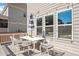 Charming outdoor patio with seating, a shade umbrella, and ambient string lights at 715 White Oak Pond Rd, Apex, NC 27523