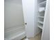 Bathroom featuring a white tub and shelving for storage at 716 Red Forest Trl, Raleigh, NC 27615