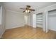 An empty bedroom with hardwood floors, a ceiling fan and a big closet at 716 Red Forest Trl, Raleigh, NC 27615