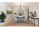 Bright dining room featuring a chandelier, modern furniture, and natural light at 716 Red Forest Trl, Raleigh, NC 27615