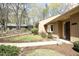 The property offers a well-maintained lawn, mature trees, and a neatly landscaped area along the side at 716 Red Forest Trl, Raleigh, NC 27615