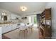 Cozy kitchen with white cabinetry, dining area, and patio access for seamless indoor-outdoor living at 716 Red Forest Trl, Raleigh, NC 27615