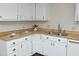 Bright kitchen with white cabinets, stainless steel sink, and laminate countertops at 716 Red Forest Trl, Raleigh, NC 27615