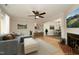 Cozy living room with ceiling fan, plush seating, and view into the adjacent dining area at 716 Red Forest Trl, Raleigh, NC 27615