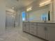 Bright bathroom featuring a shower, dual vanity, and modern fixtures at 75 Furley St., Homesite 115, Sanford, NC 27330