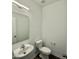 Contemporary bathroom with sink, toilet, mirror, modern lighting, and decorative flooring at 75 Furley St., Homesite 115, Sanford, NC 27330