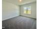 Bright bedroom with large window and plush carpet at 75 Furley St., Homesite 115, Sanford, NC 27330