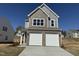 Charming two-story home featuring a brick and shake facade and a two-car garage at 75 Furley St., Homesite 115, Sanford, NC 27330