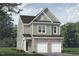 Charming two-story home with a combination of siding and brick exterior and two-car garage at 75 Furley St., Homesite 115, Sanford, NC 27330