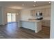 Open-concept kitchen with island, stainless steel appliances, and access to the backyard at 75 Furley St., Homesite 115, Sanford, NC 27330