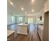 Bright, open kitchen with a large island and modern appliances and an adjoining living area at 75 Furley St., Homesite 115, Sanford, NC 27330