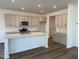 Modern kitchen featuring an island, stainless steel appliances, and shaker cabinets at 75 Furley St., Homesite 115, Sanford, NC 27330