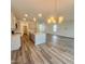 Open-concept kitchen with island seating and modern lighting, flowing into the living area at 75 Furley St., Homesite 115, Sanford, NC 27330