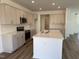 Well-equipped kitchen with a center island, stainless steel appliances and light cabinets at 75 Furley St., Homesite 115, Sanford, NC 27330