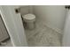 Close-up of a toilet room with hexagonal tile and white trim at 75 Furley St., Homesite 115, Sanford, NC 27330