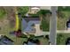 Aerial view of a well-maintained brick home with mature trees, a paved driveway, and a lush green lawn at 805 Lee St, Gibsonville, NC 27249