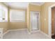 En Suite bathroom featuring tile floors, a glass enclosed shower, and a window for natural light at 805 Lee St, Gibsonville, NC 27249