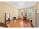 Bright bedroom with hardwood floors, two windows, and neutral paint at 805 Lee St, Gibsonville, NC 27249