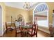 Formal dining room with hardwood floors, decorative chandelier, and ample natural light at 805 Lee St, Gibsonville, NC 27249