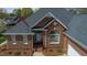 Charming brick home with a well-manicured lawn, white trim, and an inviting front porch at 805 Lee St, Gibsonville, NC 27249