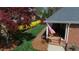 Aerial view of rear exterior with a well-manicured lawn and garden at 805 Lee St, Gibsonville, NC 27249