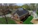 Classic red brick home with a well-maintained lawn and mature trees offering privacy at 805 Lee St, Gibsonville, NC 27249