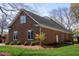 Well-maintained brick home with lush landscaping, mature trees, and a manicured lawn at 805 Lee St, Gibsonville, NC 27249