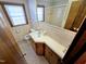 Bathroom with a window, sink, toilet, and bathtub at 807 Everett St, Burlington, NC 27215