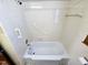 Tiled bathtub and shower area in a clean bathroom with essential fixtures at 807 Everett St, Burlington, NC 27215