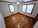 Bright bedroom with hardwood floors, natural light from two windows, and a ceiling fan at 807 Everett St, Burlington, NC 27215